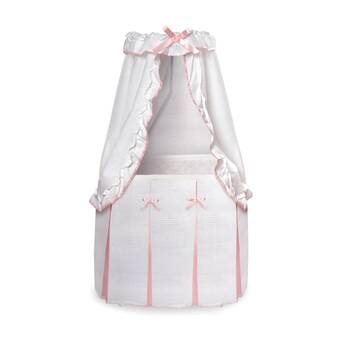 pink moses basket with drapes