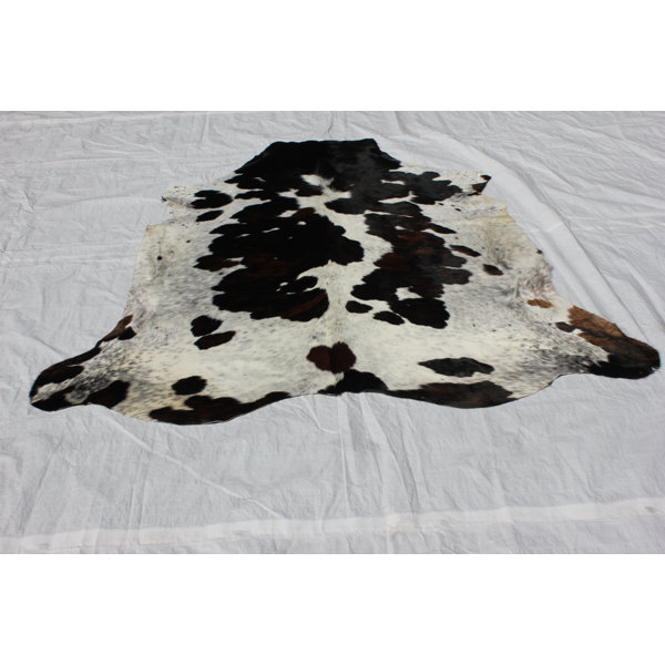 Underwood Hand-Woven Cowhide Black/Ivory Area Rug by Loon Peak