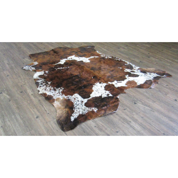 Tolland Hand-Woven Cowhide Brown Area Rug by Loon Peak