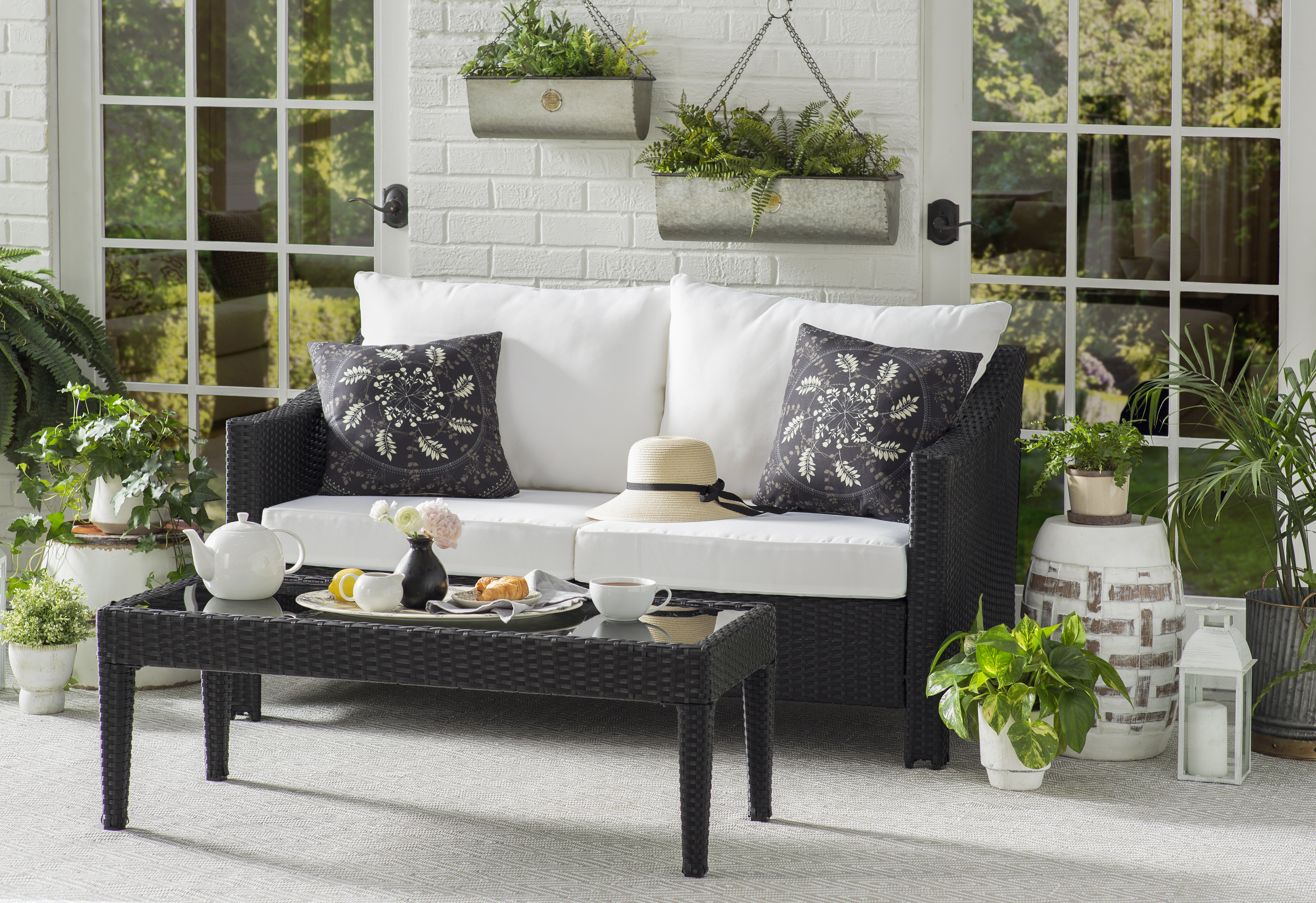 outdoor sitting area decorated with wall-mounted plants and planters
