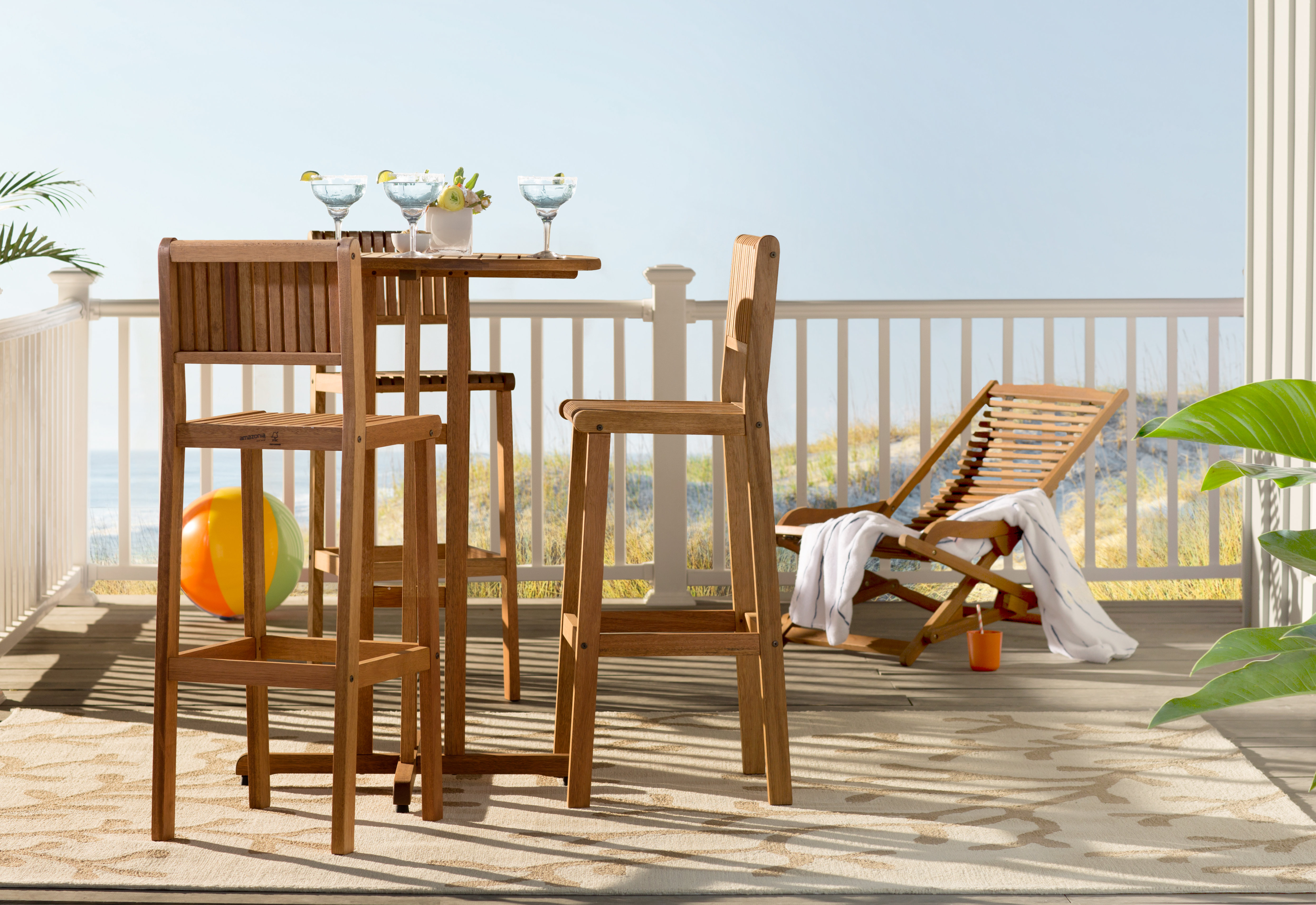 tall outdoor table setting on a deck