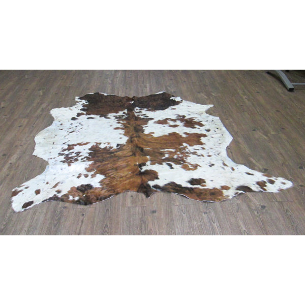 Wendell Hand-Woven Cowhide Brown/White Area Rug by Loon Peak